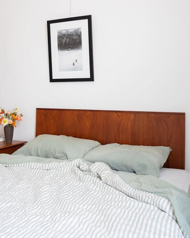 21. Warm Walnut Headboard With Soft Sage Bedding - mid century bedroom ideas