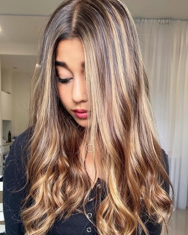 2. Bright Face-Framing Caramel Lights on a Golden Balayage - Caramel Balayage with Highlights