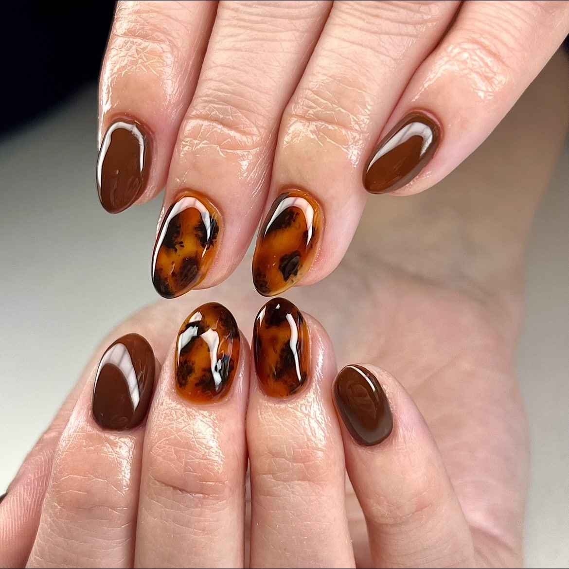 2. Autumn Tortoiseshell Glow - brown fall nail ideas