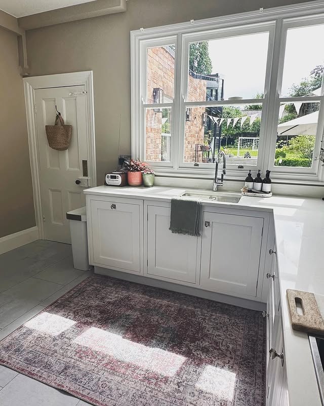 10. Neutral Stone Kitchen with Soft Rose Distressed Rug - kitchen rug ideas