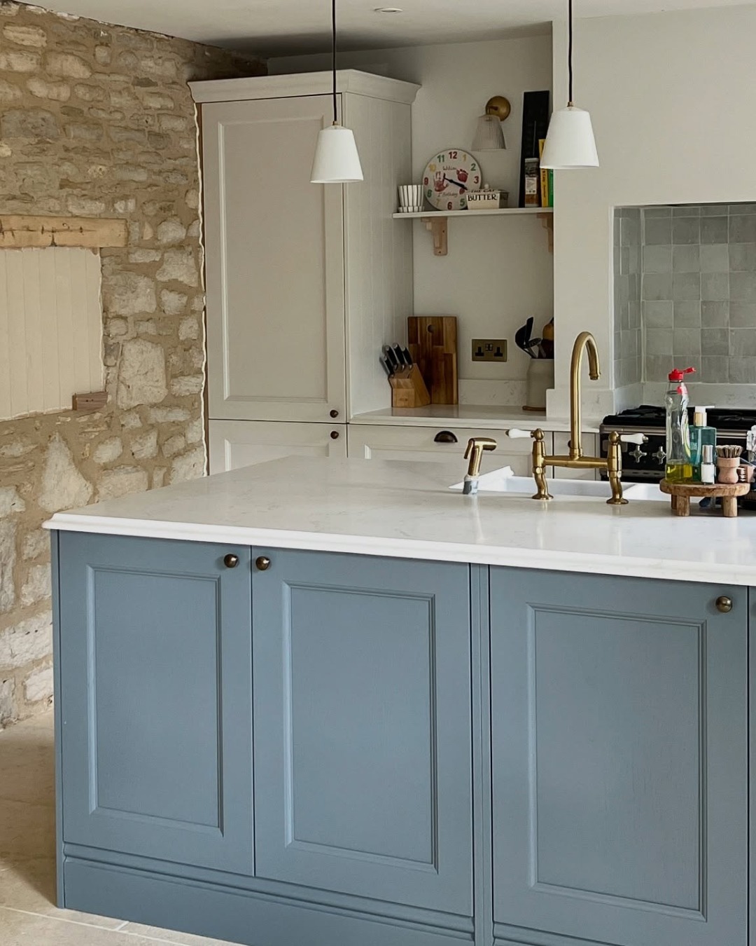 5. Dusty Blue Island with Stone & Brass Detailing - two tone kitchen ideas