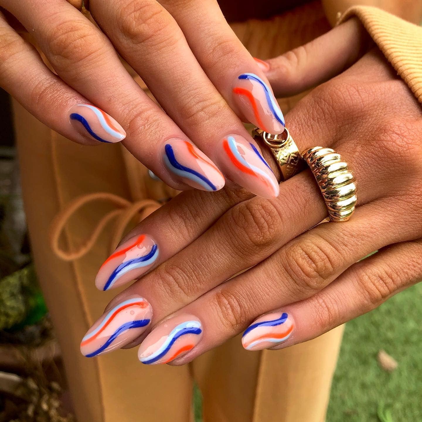 8. Sunset Wave Accent Almonds - caribbean nail ideas