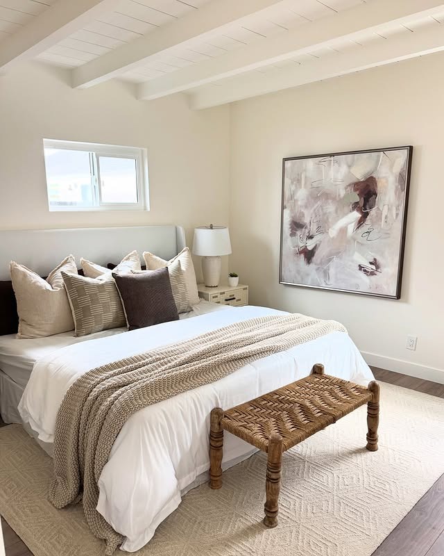 10. Airy Cream Sanctuary with Bold Artwork - black and cream bedroom ideas