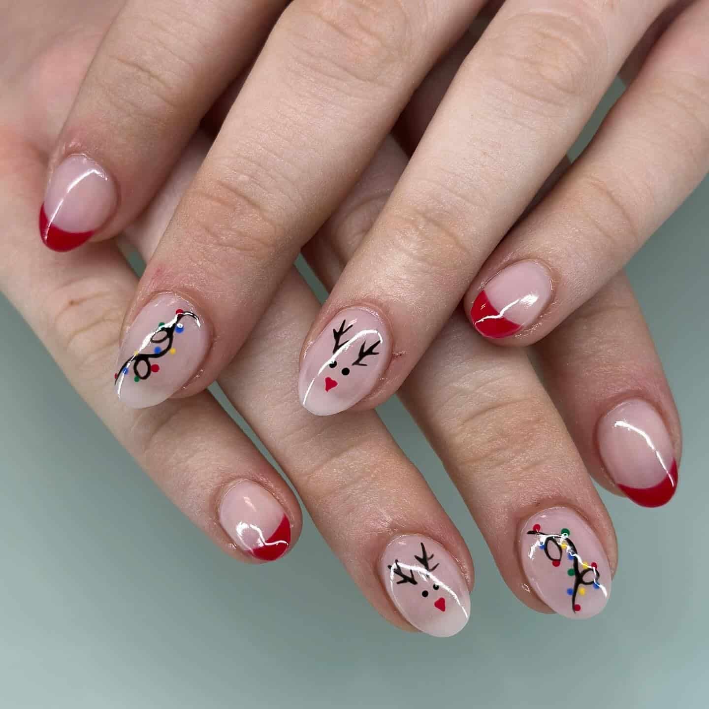 4. Red French Tips With Cute Reindeer & Light Details - christmas lights nail ideas