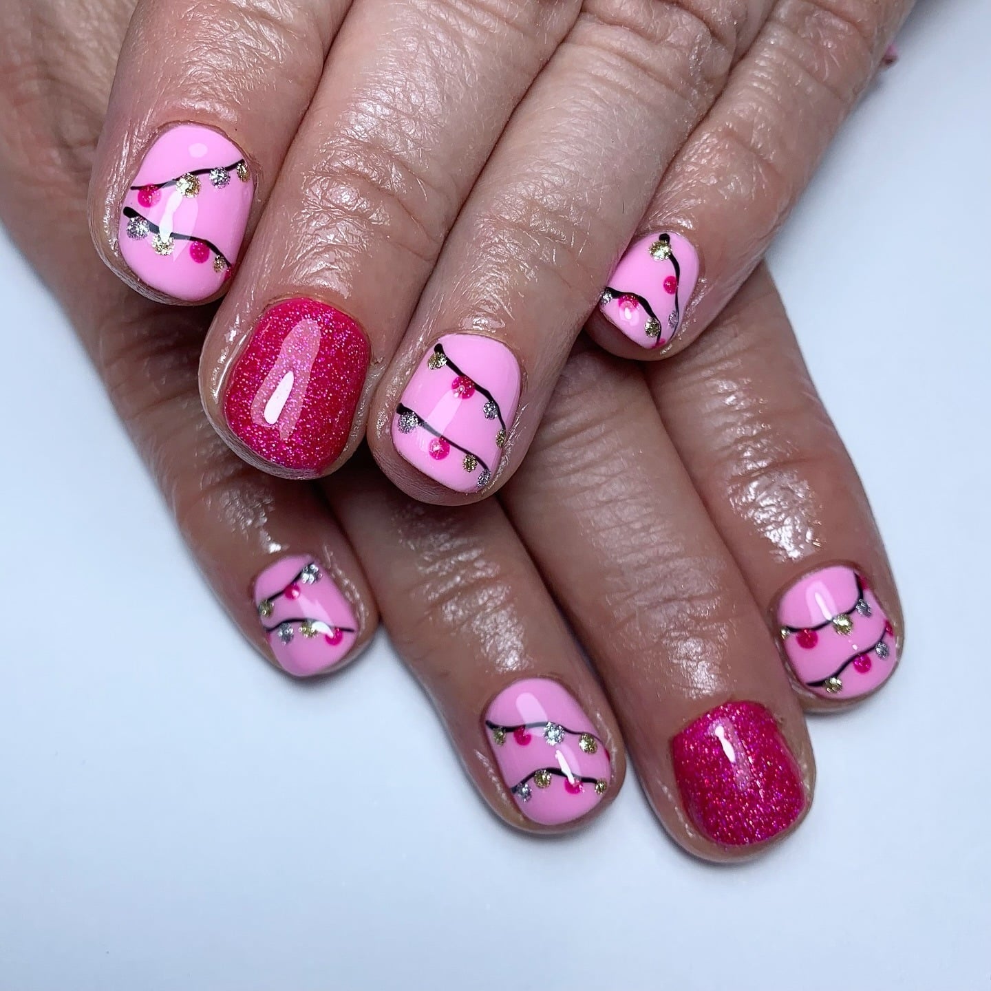 5. Pink Christmas Lights With Gold Accents - christmas lights nail ideas