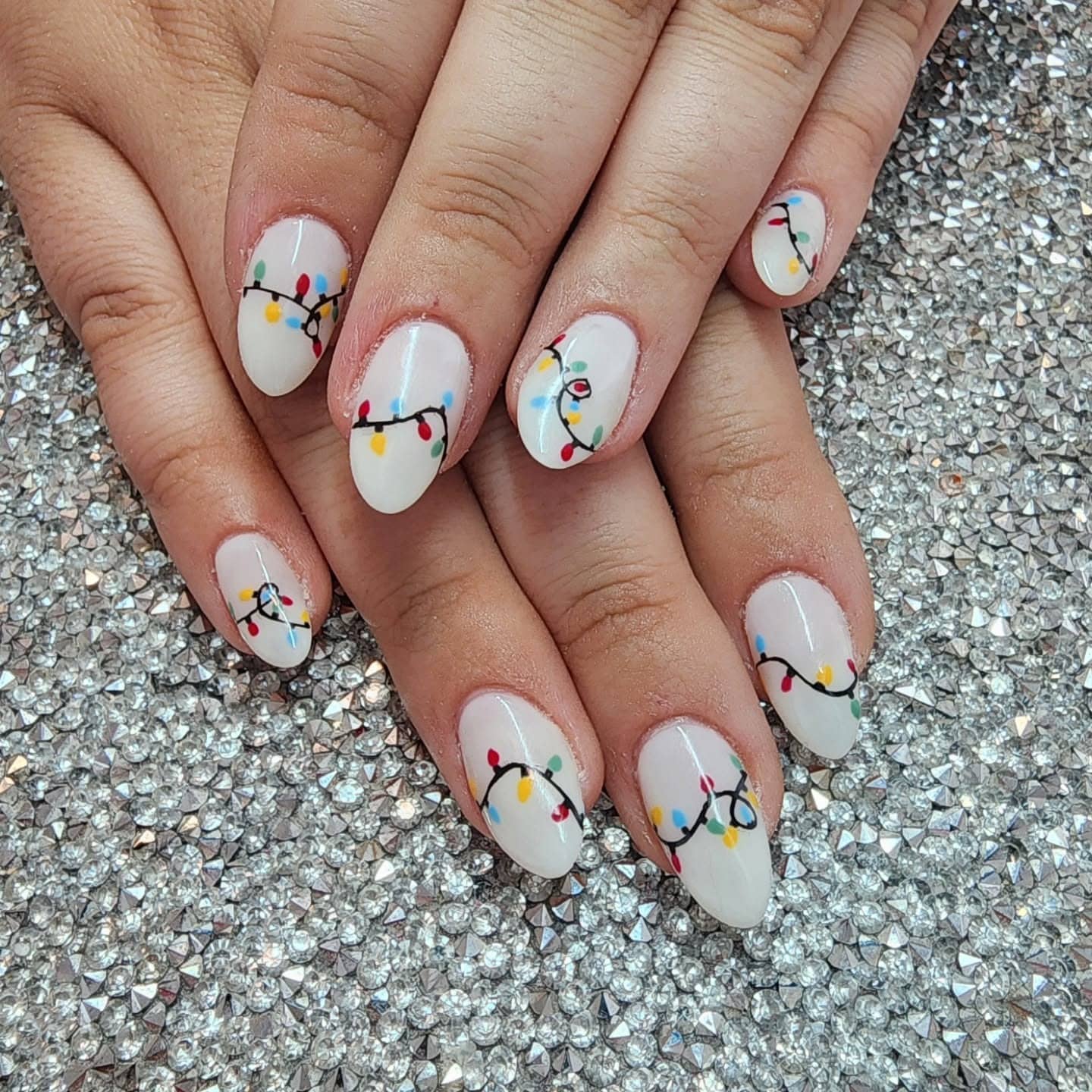 8. Frosty White Christmas Lights on Almond Nails - christmas lights nail ideas