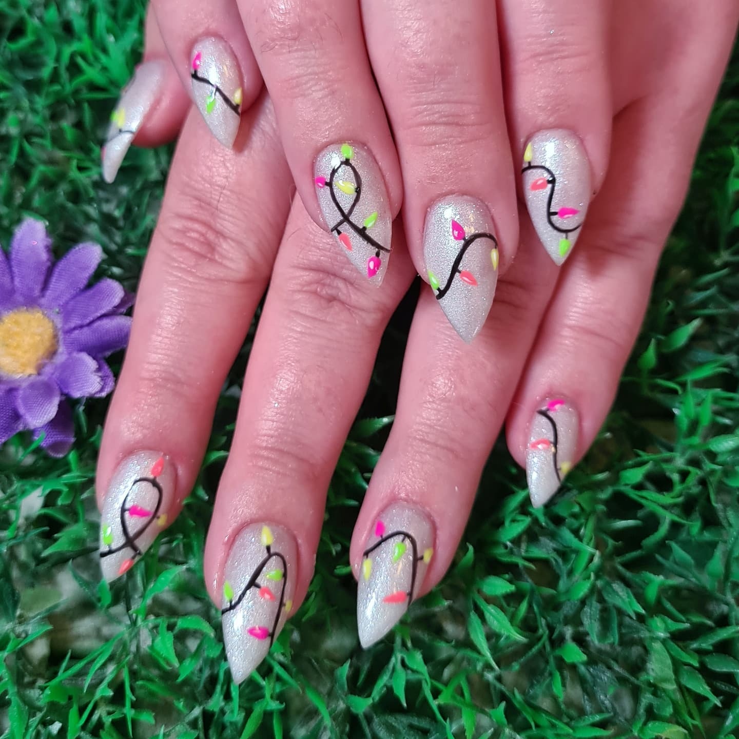 17. Icy Silver Almond Nails With Neon Light Strings - christmas lights nail ideas