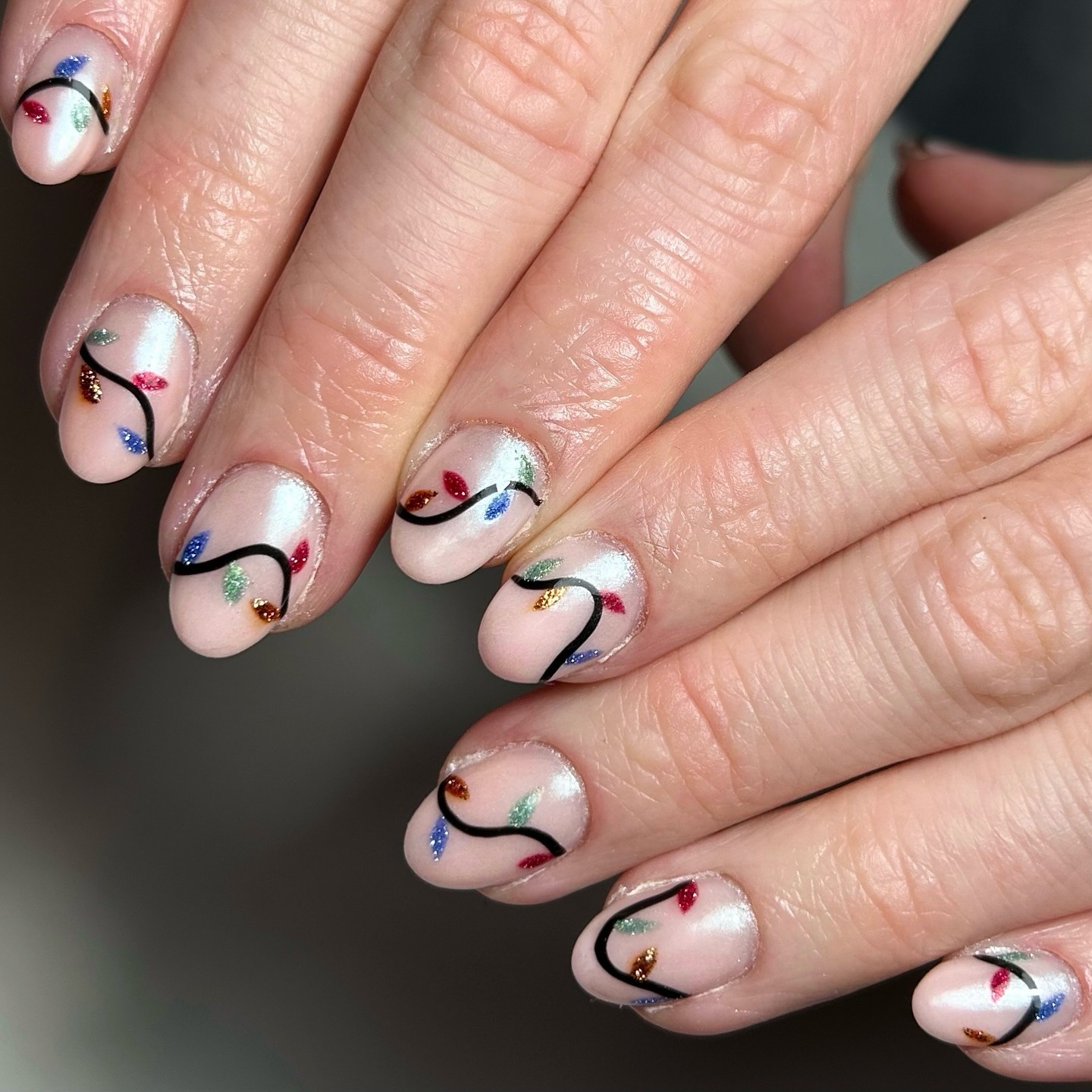 22. Soft Pearl Nude Nails With Glitter Bulb Christmas Lights - christmas lights nail ideas