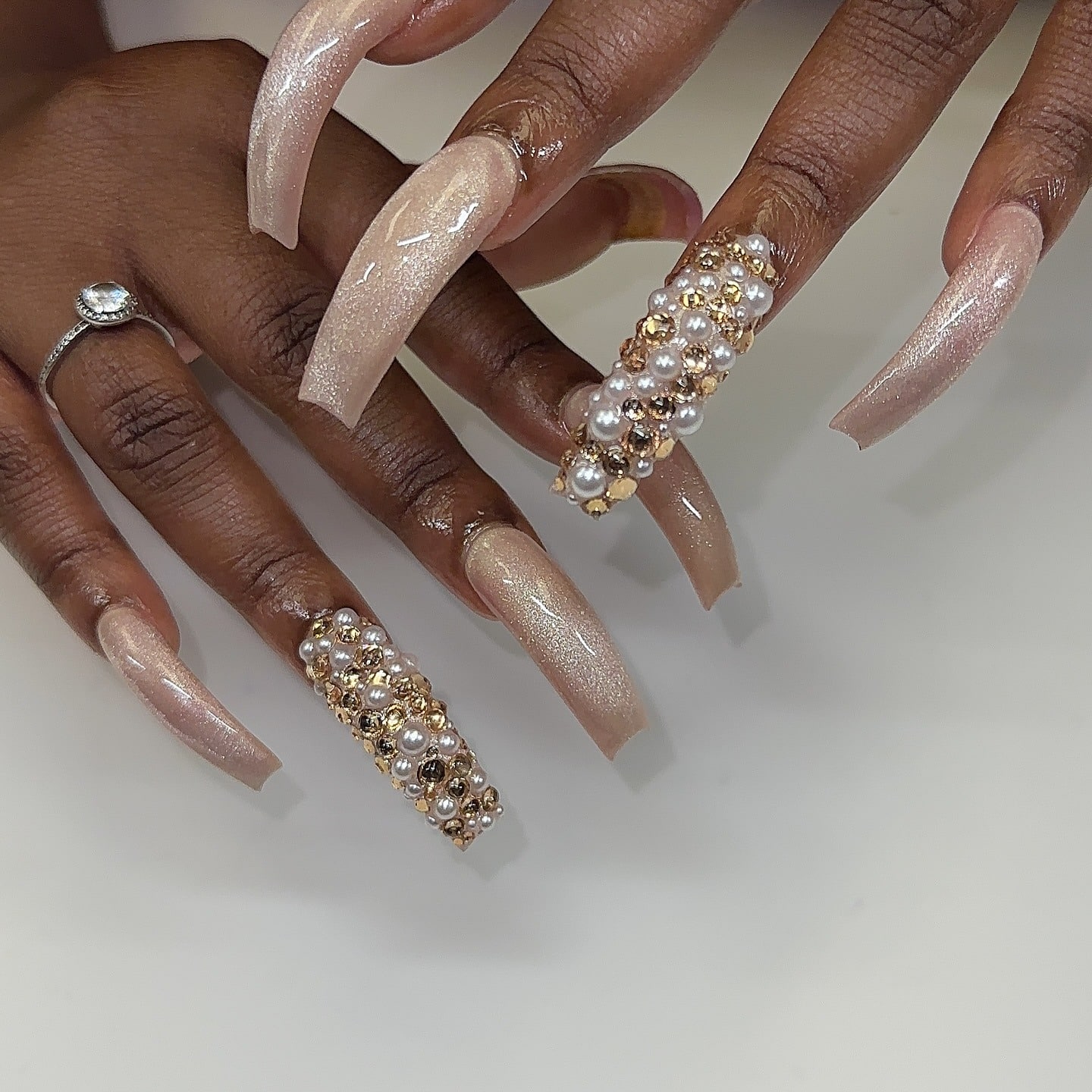 9. Champagne Pearl Curve Luxury Nails - curved nail ideas