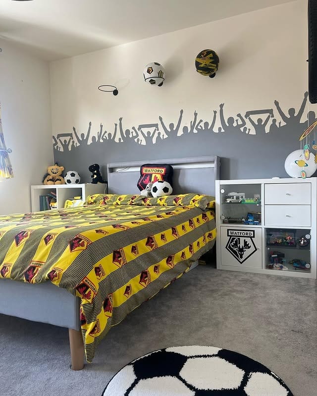 5. Crowd-Mural Feature Wall in Grey and Yellow - football bedroom ideas