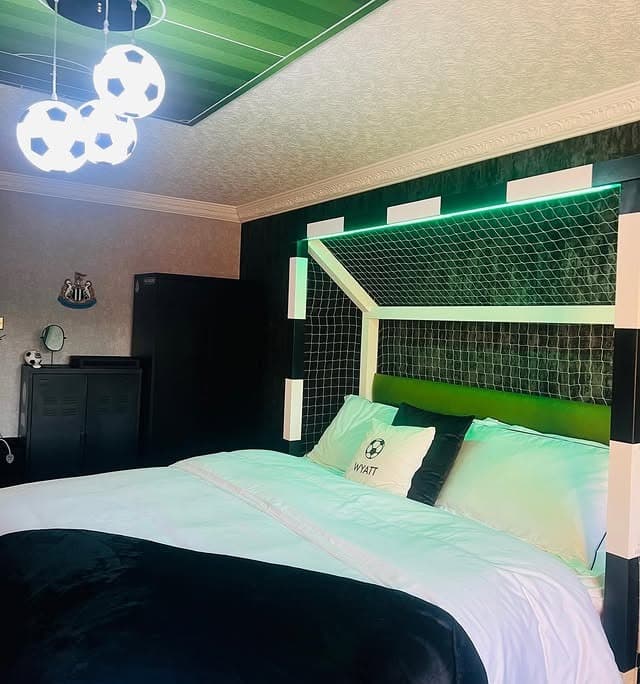 18. Goal-Frame Headboard with Green Lighting Detail - football bedroom ideas