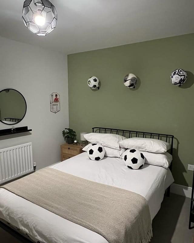 22. Sage Feature Wall with Displayed Match Balls - football bedroom ideas