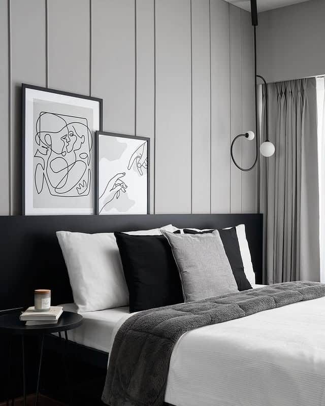 8. Soft Grey Vertical Panels with Monochrome Artwork - grey wall bedroom ideas
