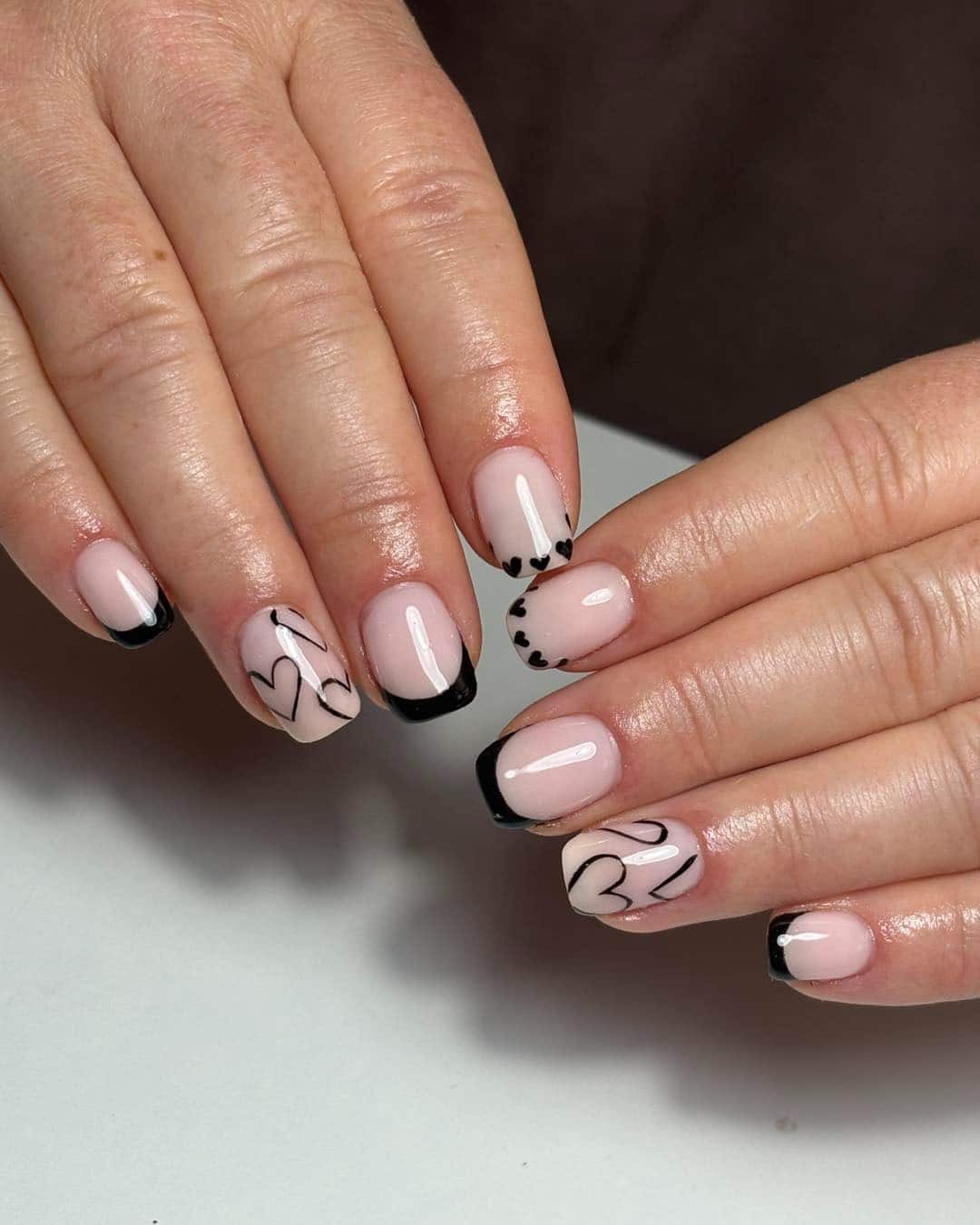 4. Short French Tips with Black Hearts and Line Art - cute french nail ideas