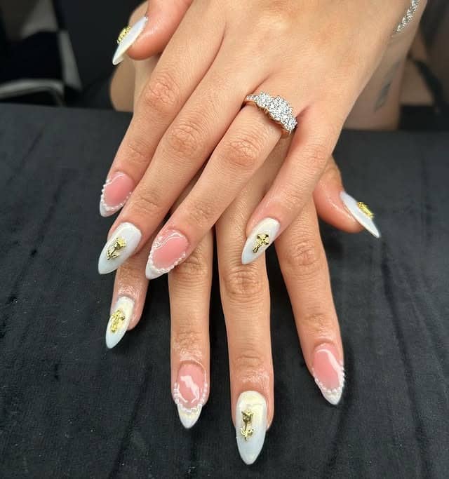 5. Milky White French Almonds with Gold Charms - cute french nail ideas