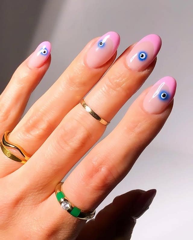 16. Pink French Fade with Evil Eye Motifs - cute french nail ideas
