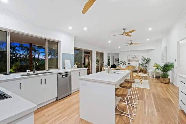 1. Coastal White Flow with Warm Timber Accents - open lounge kitchen ideas