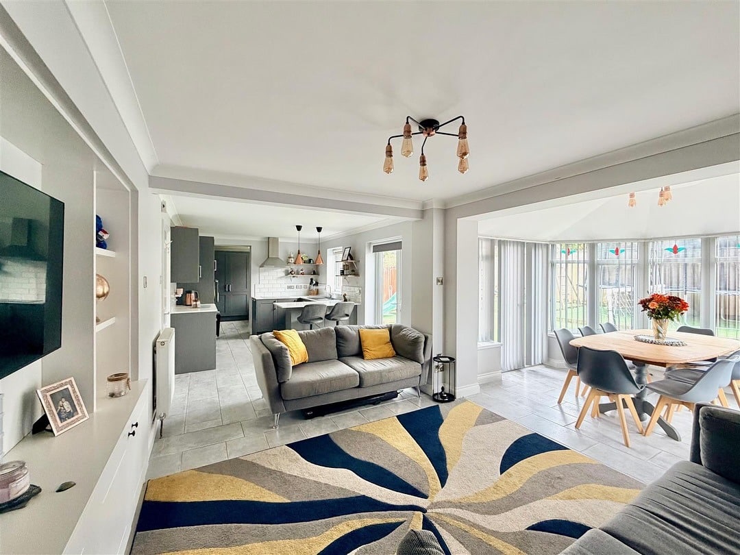 3. Charcoal Grey Social Hub with Sunlit Dining - open lounge kitchen ideas