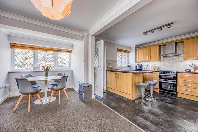 4. Warm Oak Kitchen with Soft Grey Dining Corner - open lounge kitchen ideas