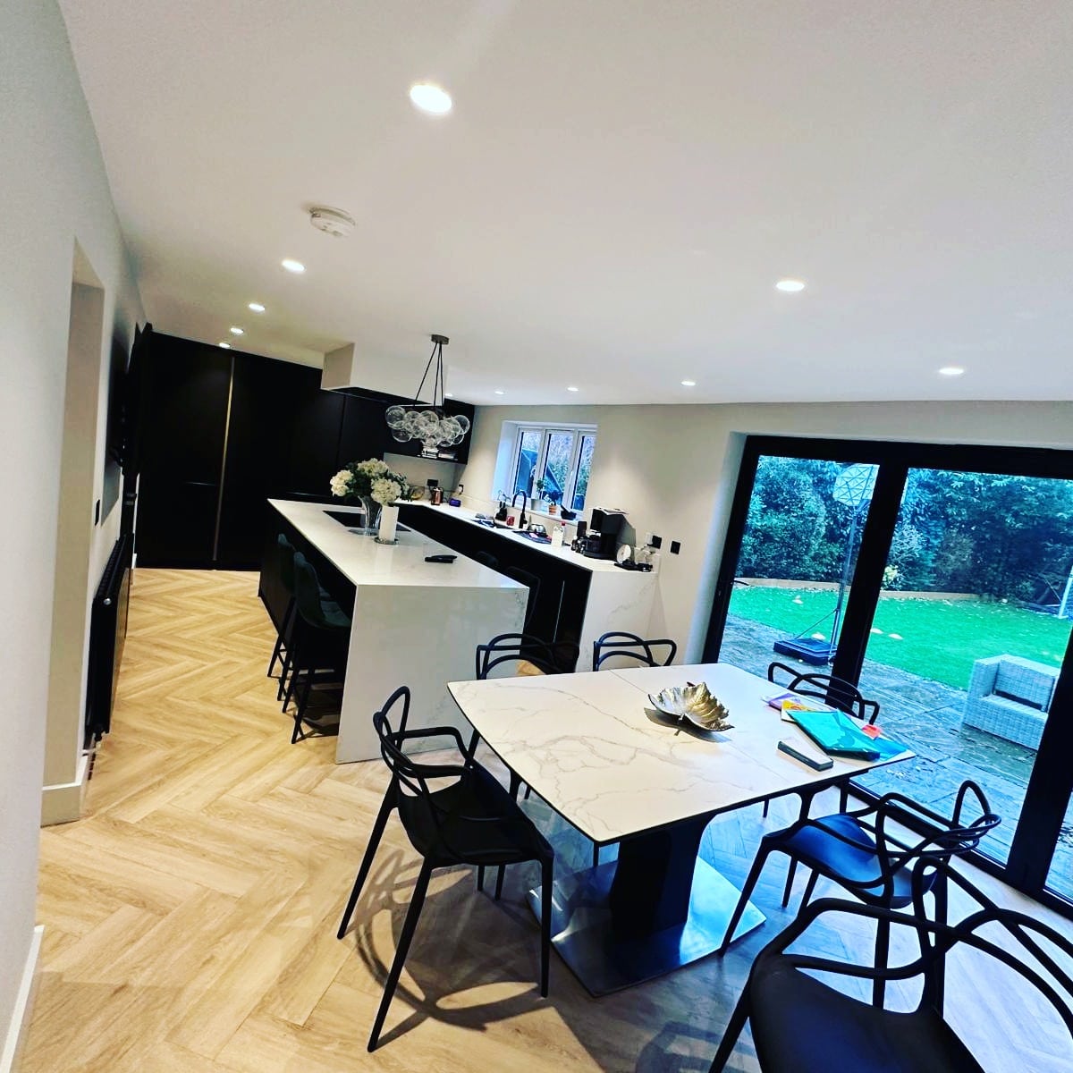 6. Black-and-White Contemporary Entertainer’s Layout - open lounge kitchen ideas