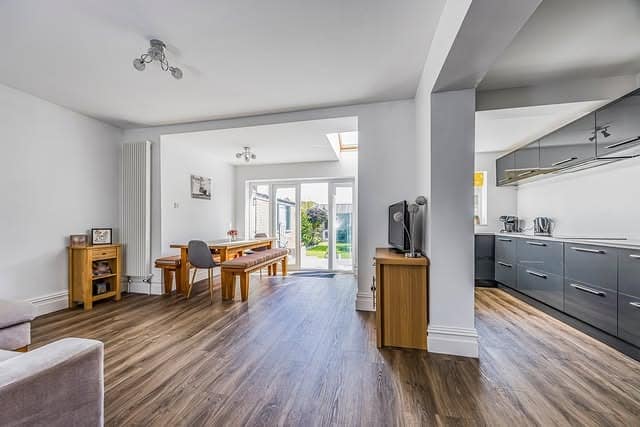 7. Grey Gloss Kitchen with Warm Wood Dining Extension - open lounge kitchen ideas