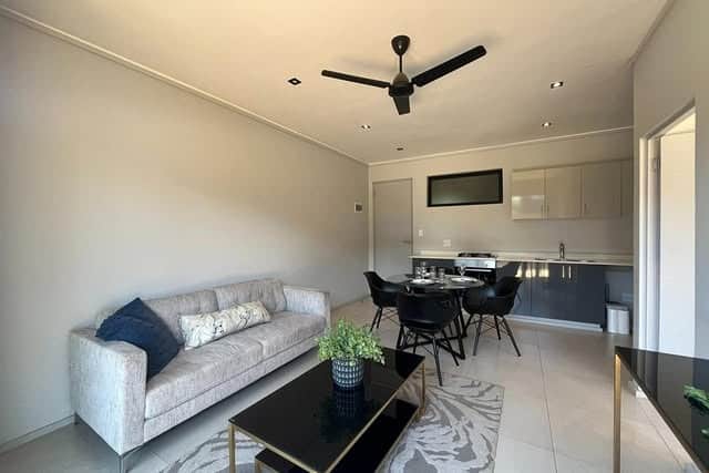 11. Minimalist Charcoal and Cream Compact Layout - open lounge kitchen ideas