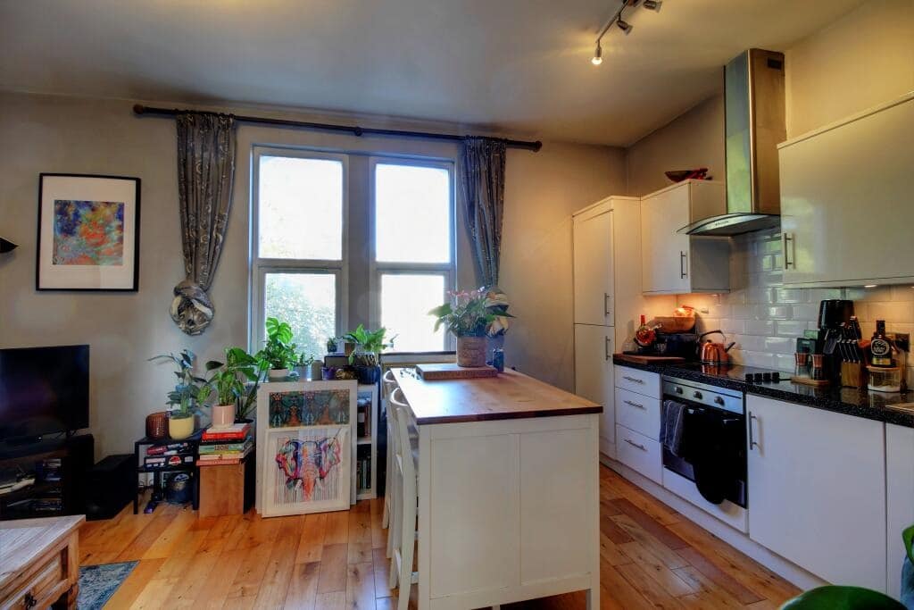 15. Eclectic Bright Lounge with White Kitchen Blend - open lounge kitchen ideas