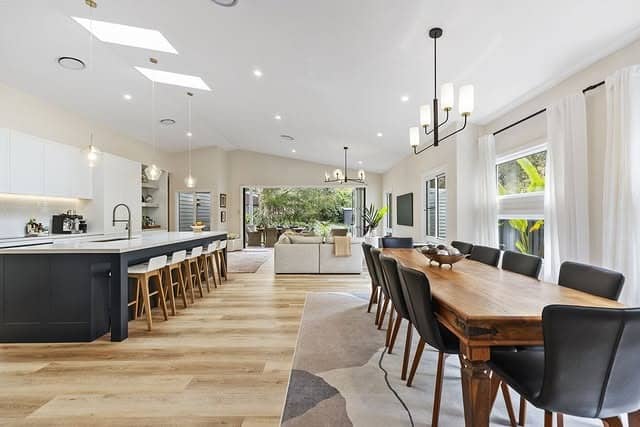 18. Monochrome Island Kitchen with Warm Wood Dining - open lounge kitchen ideas