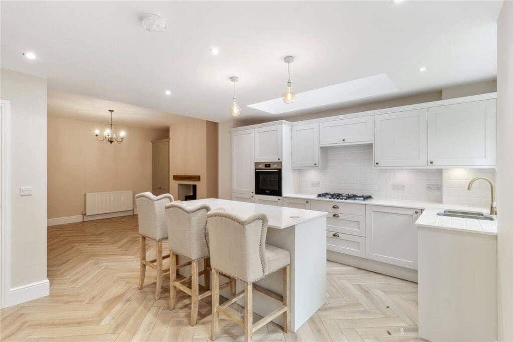 19. Classic White Shaker Kitchen with Herringbone Flooring - open lounge kitchen ideas