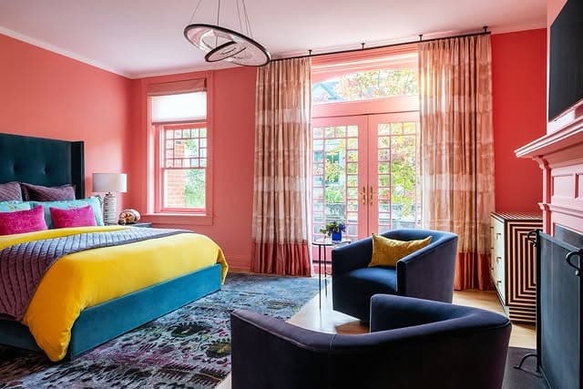 21. Bold Coral Walls with Jewel-Tone Contrast - coral bedroom ideas