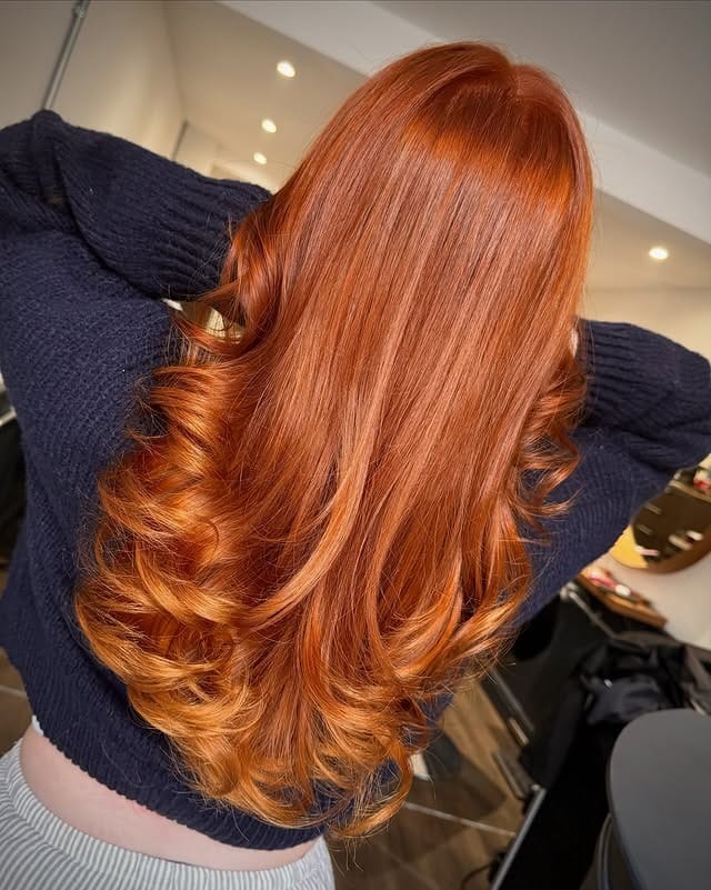 15. Bright Copper Curls with a Soft Finish - Copper Hair Color