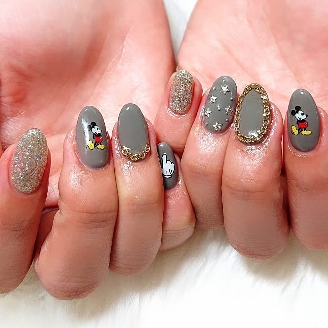 16. Grey Character Art Almond Nails with Glitter Accents - dark color nail ideas