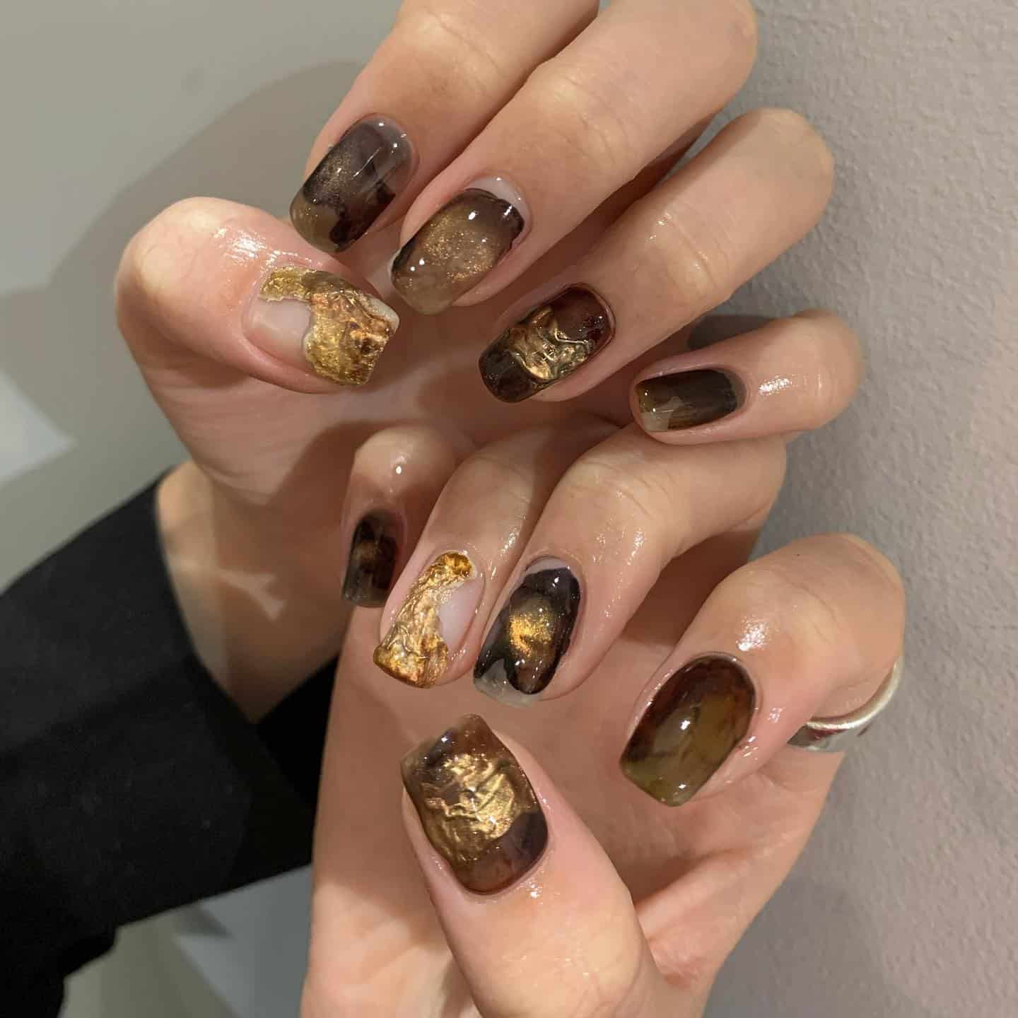 19. Smoky Amber Marble Nails with Gold Foil - dark color nail ideas