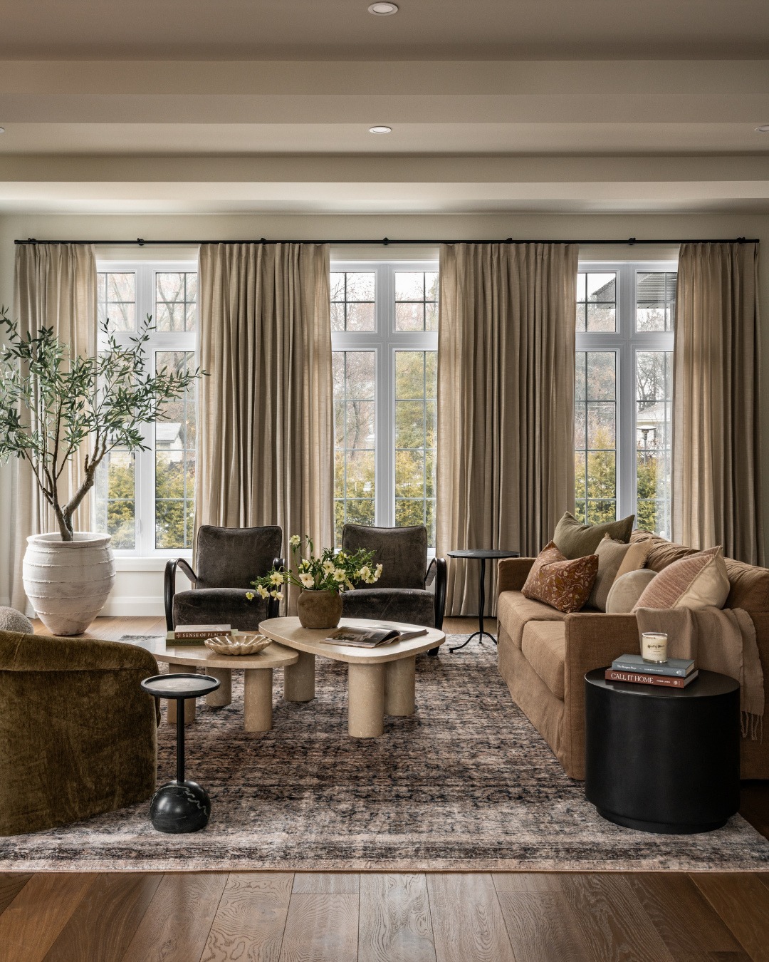 14. Earth-Toned Elegance with Layered Textures and Deep Flooring - dark wood floor living room ideas