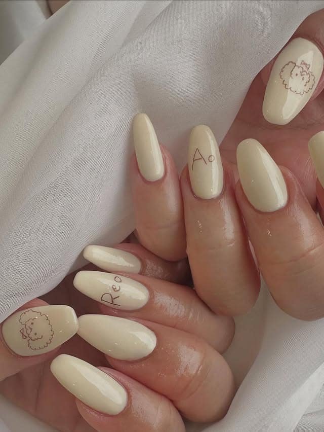 18. Warm Ivory Nails with Fine Line Pup Art - dog nail ideas