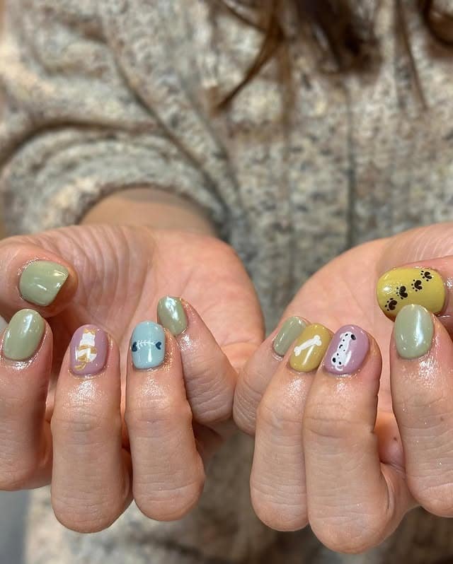 21. Sage & Pastel Dog-Themed Mix Nails - dog nail ideas