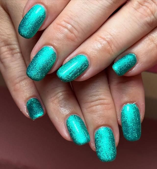 5. Shimmering Aqua-Emerald Smooth Finish - emerald nail ideas