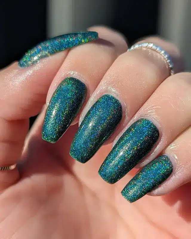 6. Deep Emerald Holographic Glow - emerald nail ideas