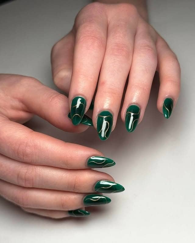 7. Gloss Emerald Swirl Detailing on Almond Tips - emerald nail ideas