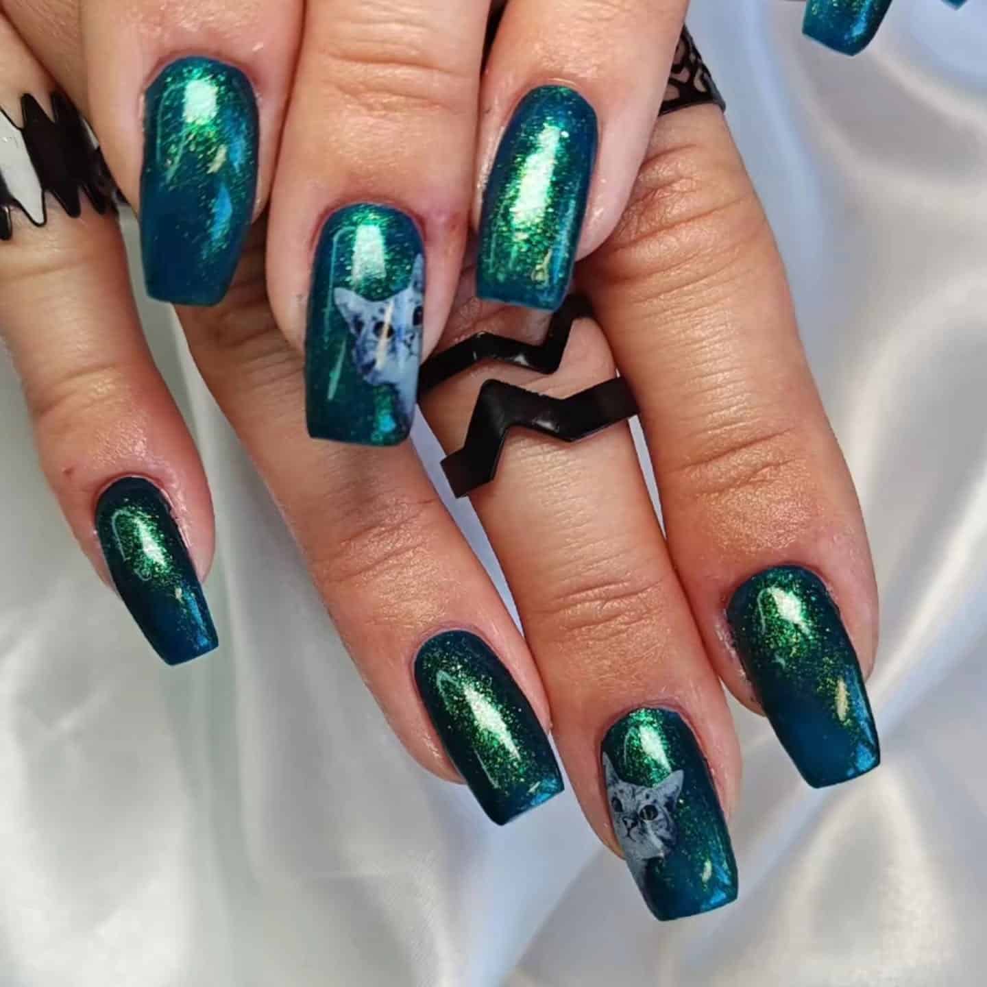 9. Emerald Cat-Eye Shimmer With Subtle Art Accent - emerald nail ideas
