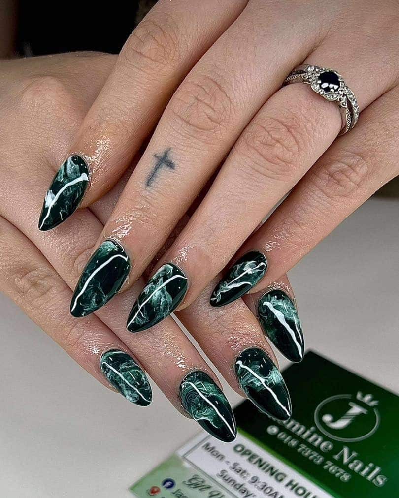 10. Dark Marble Emerald With Fine White Veining - emerald nail ideas