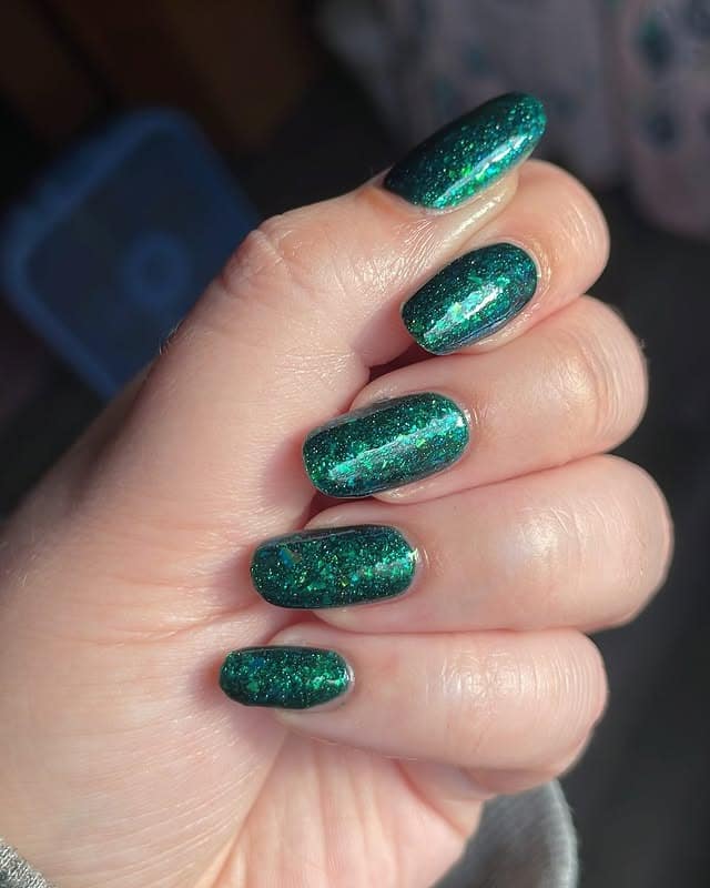 14. Emerald Glitter Overlay in Rounded Shape - emerald nail ideas