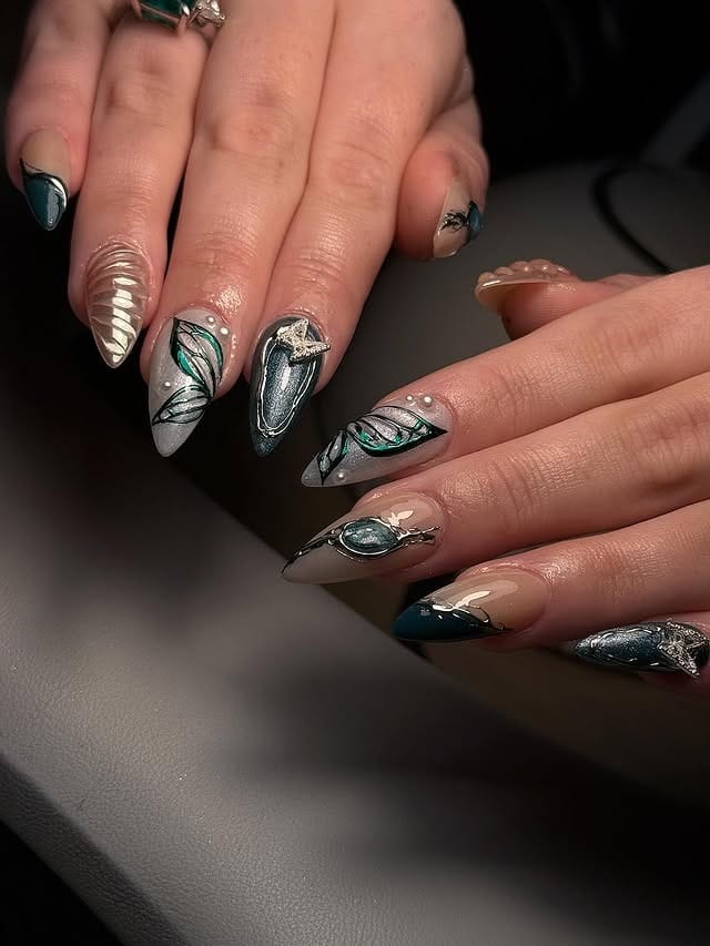 16. Artistic Emerald Foil and Leaf Design Almond Set - emerald nail ideas