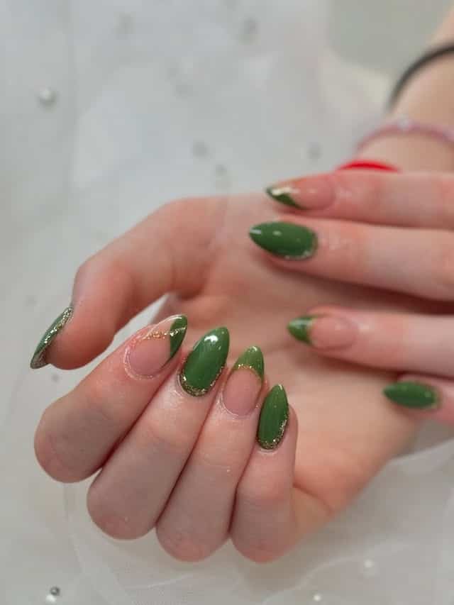 17. Green Almond Nails With Gold Glitter French Trim - emerald nail ideas