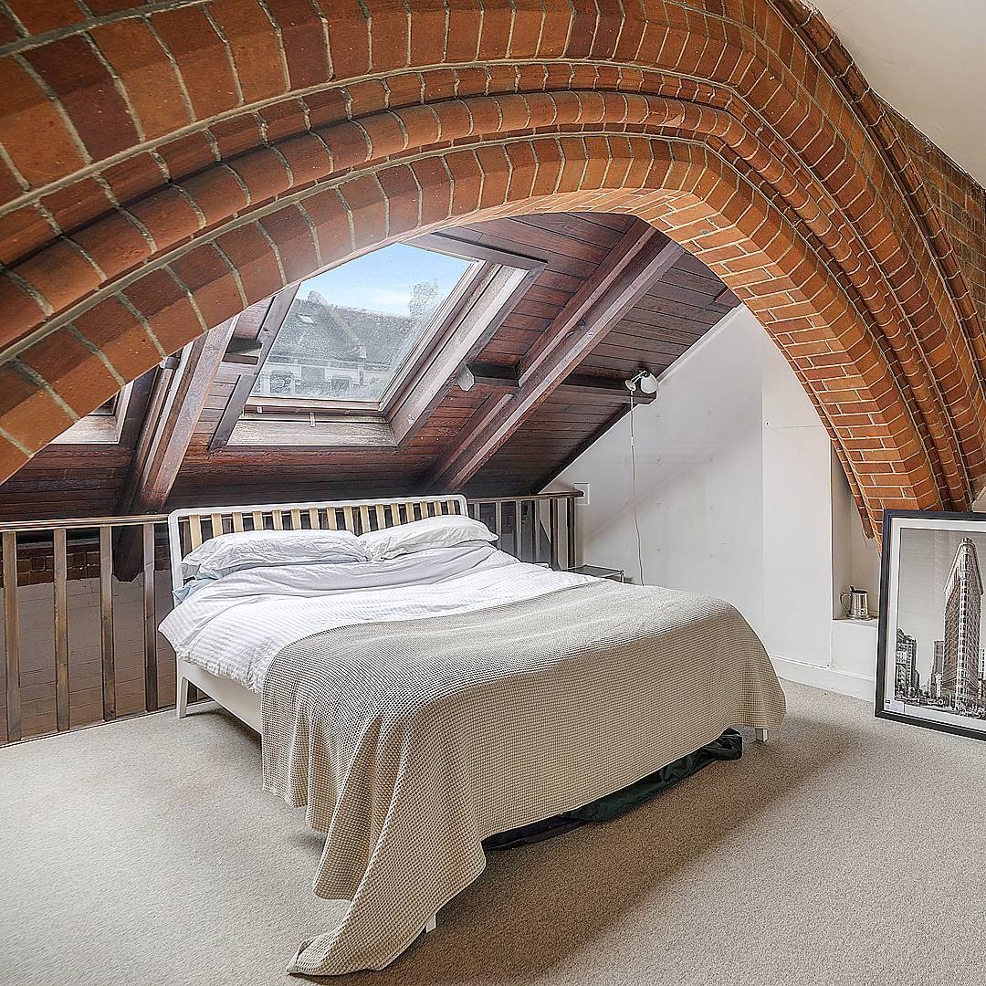 8. Gothic Loft Bedroom with Warm Brick and Cream Neutrals - cool bedroom ideas