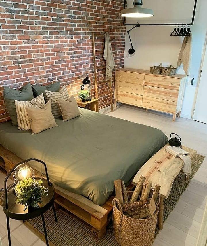 11. Industrial Brick Retreat with Earthy Greens - cool bedroom ideas