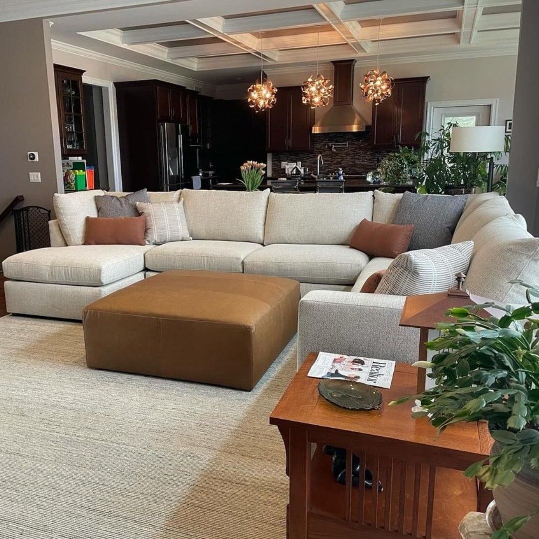 14. Cream Sectional with Cognac Ottoman Contrast - sectional living room ideas