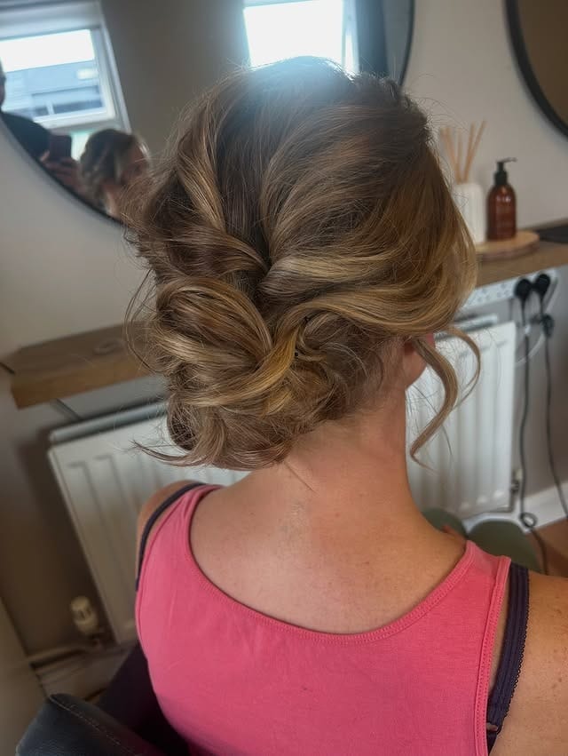 7. Romantic Textured Low Bun on Warm Caramel Blonde - Summer Hairstyles