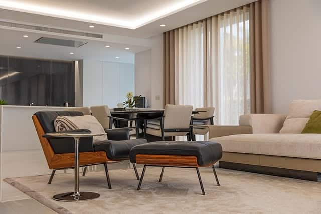 3. Minimalist Comfort in Taupe, Charcoal & Wood Accents - elegant living room ideas