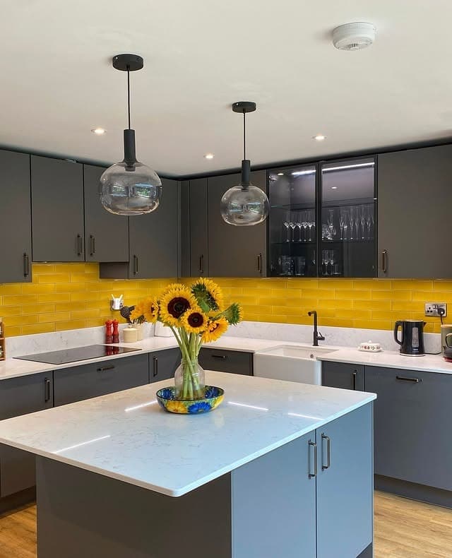 3. Grey Kitchen with Golden Tile Statement Wall - yellow and grey kitchen ideas